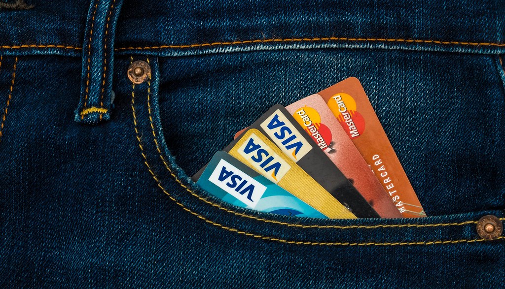 Payment cards tucked into a jeans pocket