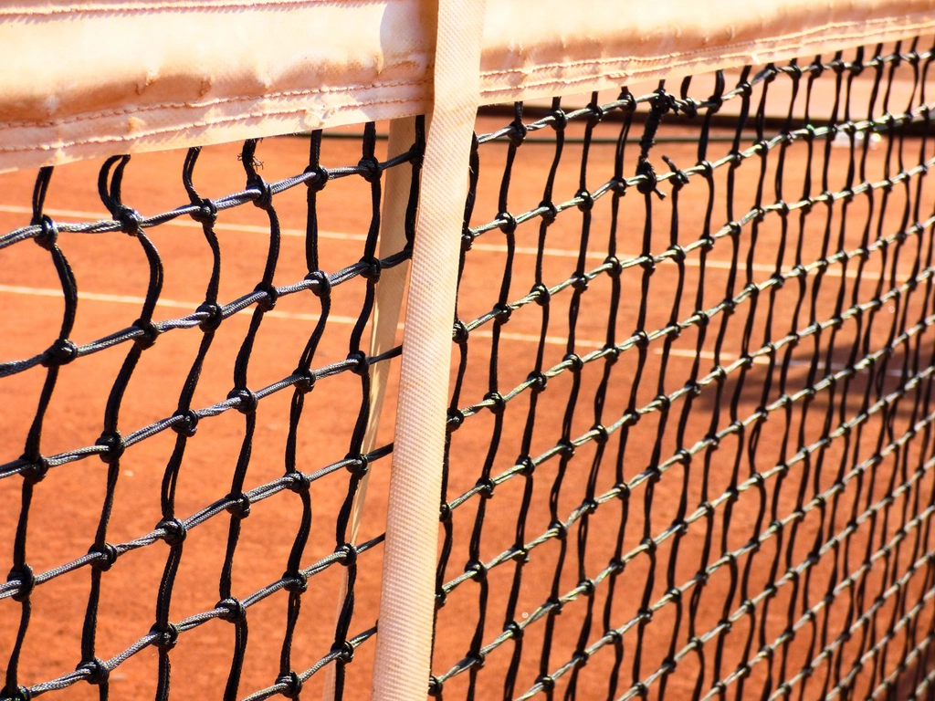 Tennis racket resting on a court surface