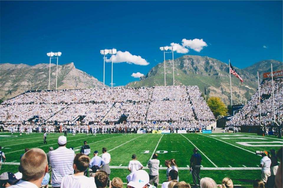 Football on a grassy field under stadium lights